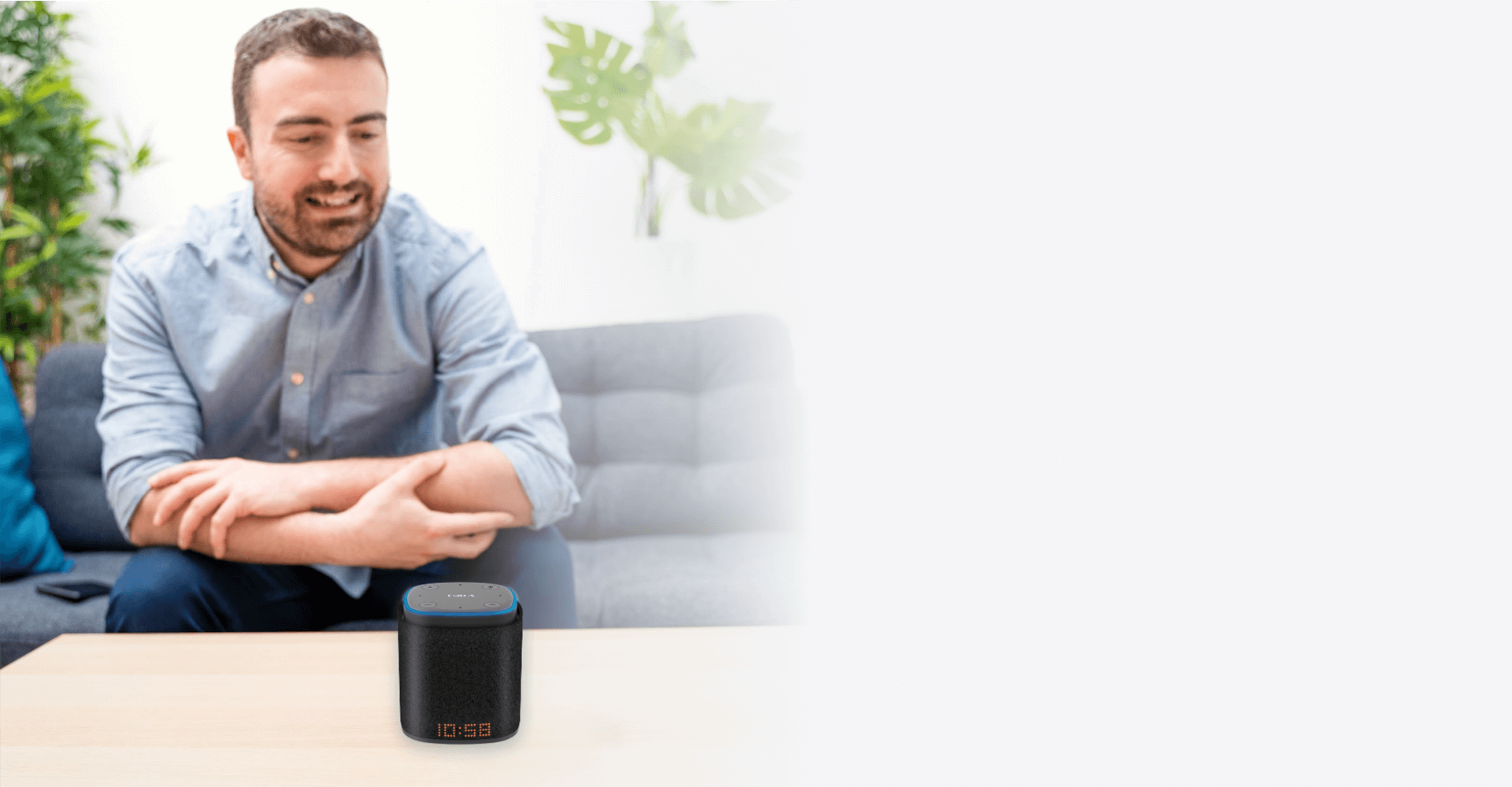 A man sitting at a table using iFORA IntelliSpeaker