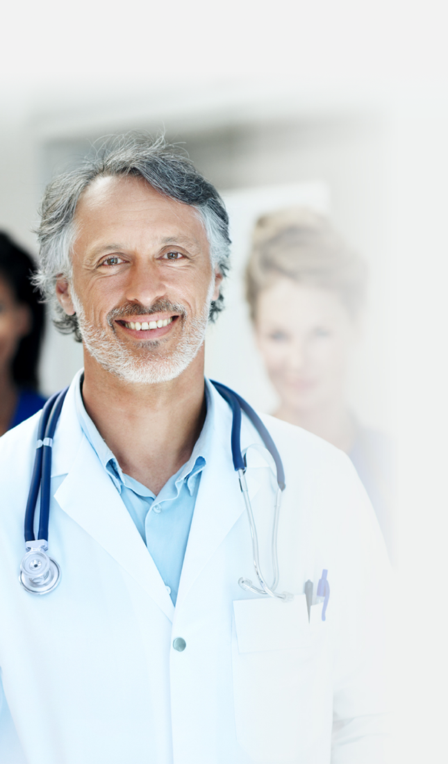 A professional male physician smiling