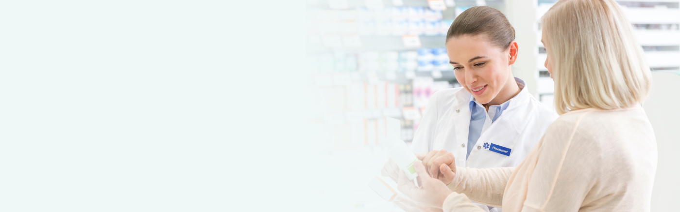 A customer consulting with a pharmacist in a pharmacy