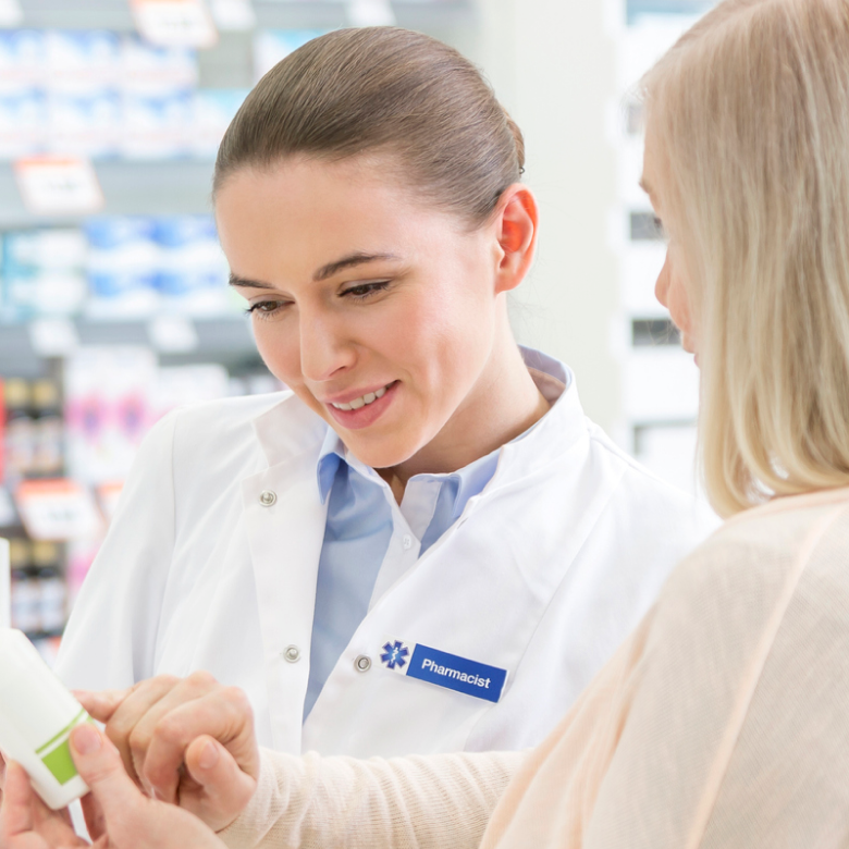 A customer consulting with a pharmacist in a pharmacy