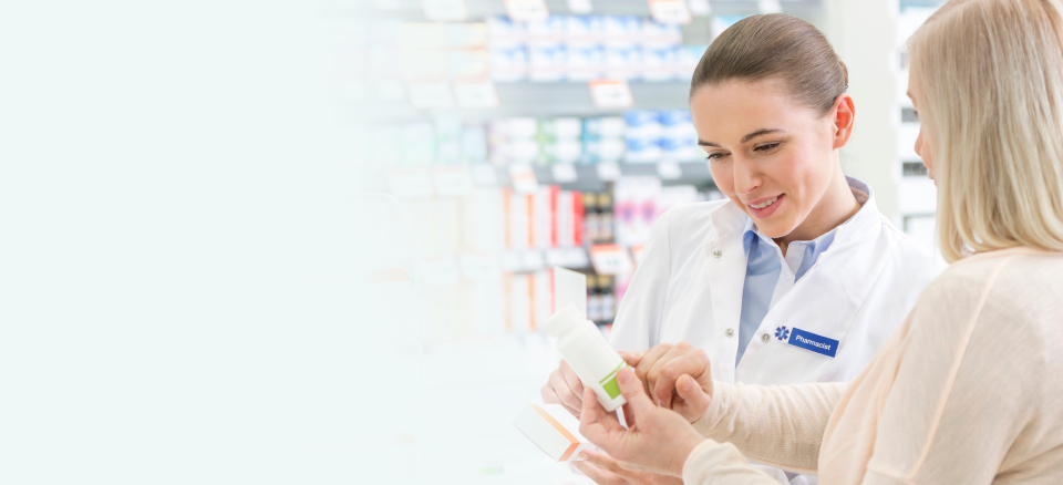 A customer consulting with a pharmacist in a pharmacy