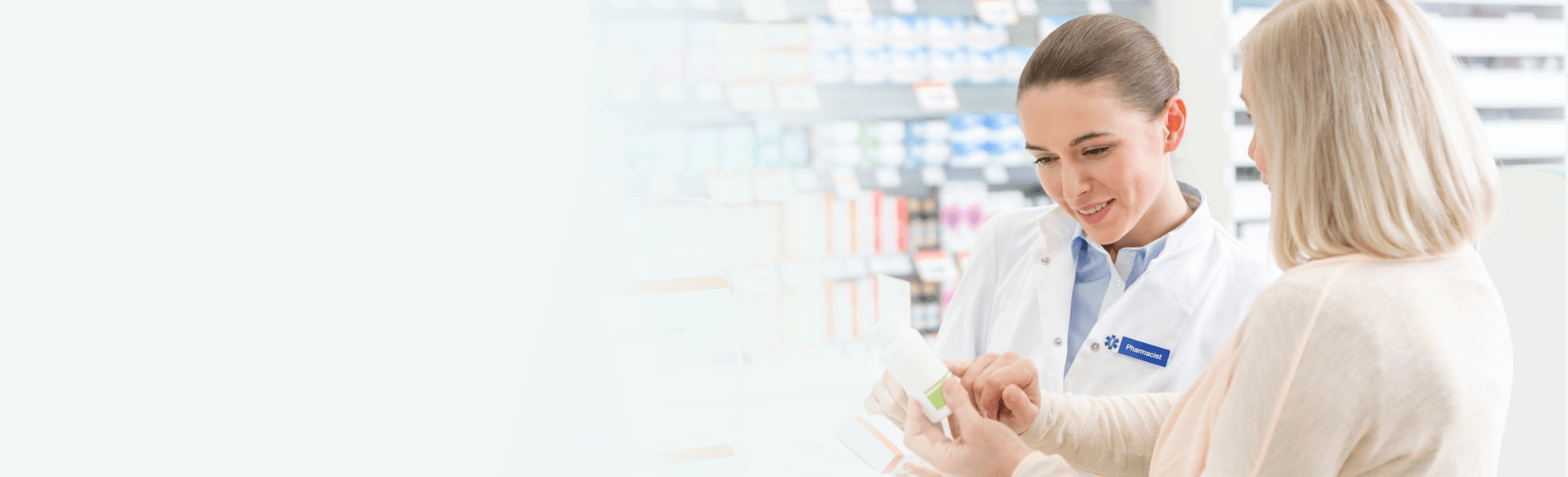 A customer consulting with a pharmacist in a pharmacy