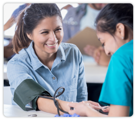 Physician assisting patient with blood pressure measurement